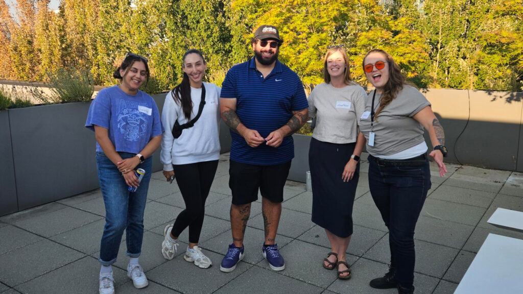 Five people stand together.