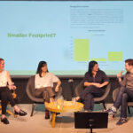 Four people seated on a stage.