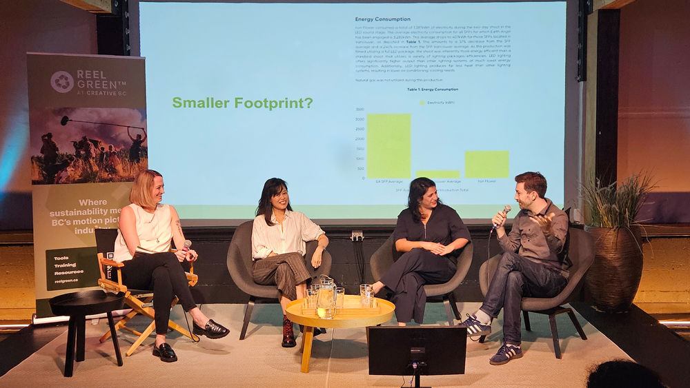 Four people seated on a stage.